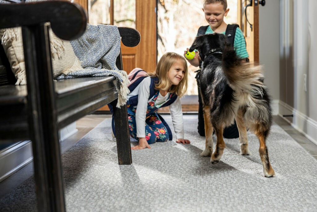 Kids playing with dog on carpet floor | The Carpet Factory Super Store